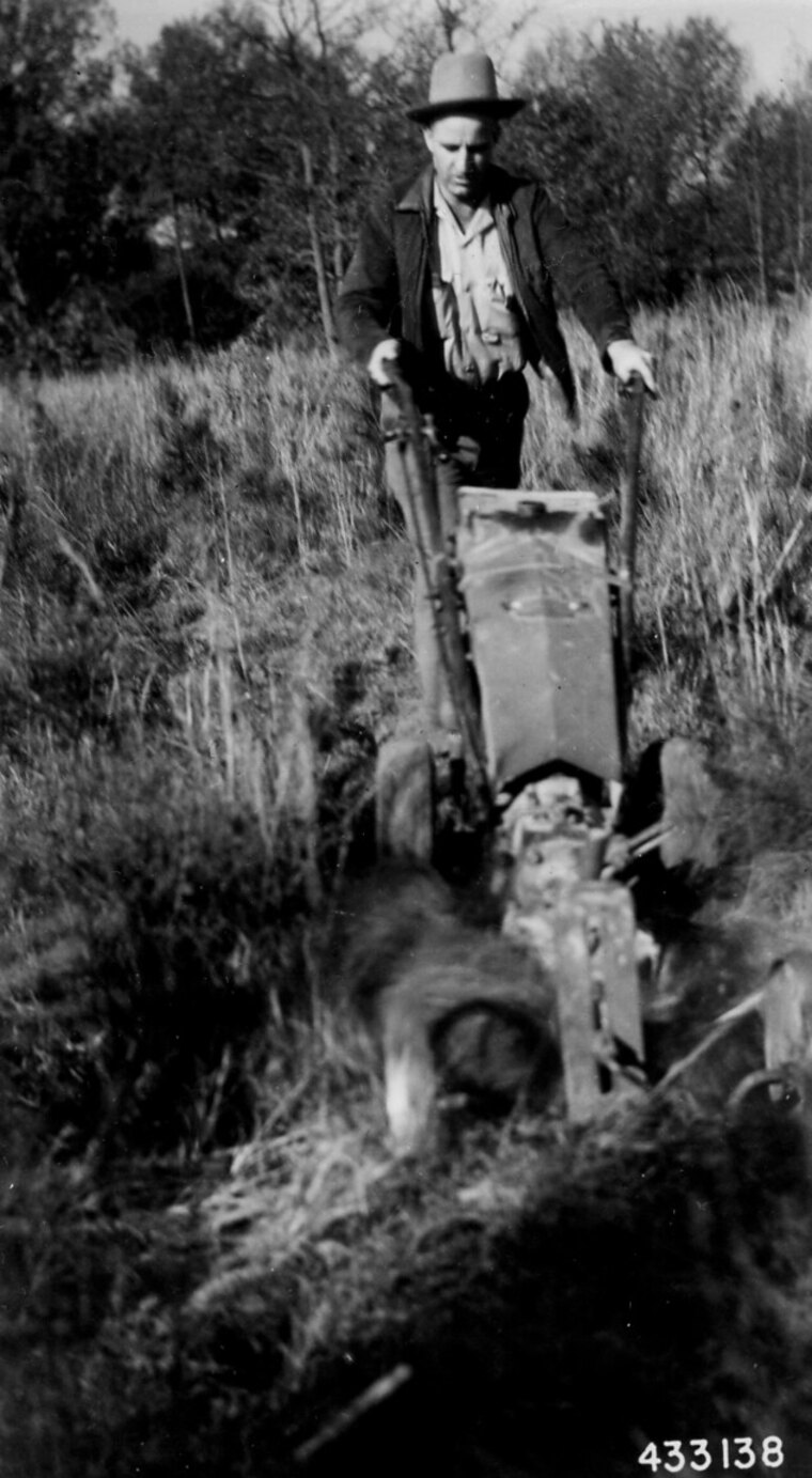 A photograph of a tractor and plough, the source